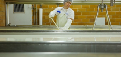 Photo of Maytag production worker making cheese